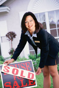 Debra with 'House Sold' sign